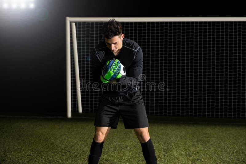 Goalkeeper catches the ball in the stadium royalty free stock images Goalkeeper catches the ball in the stadium royalty free stock images