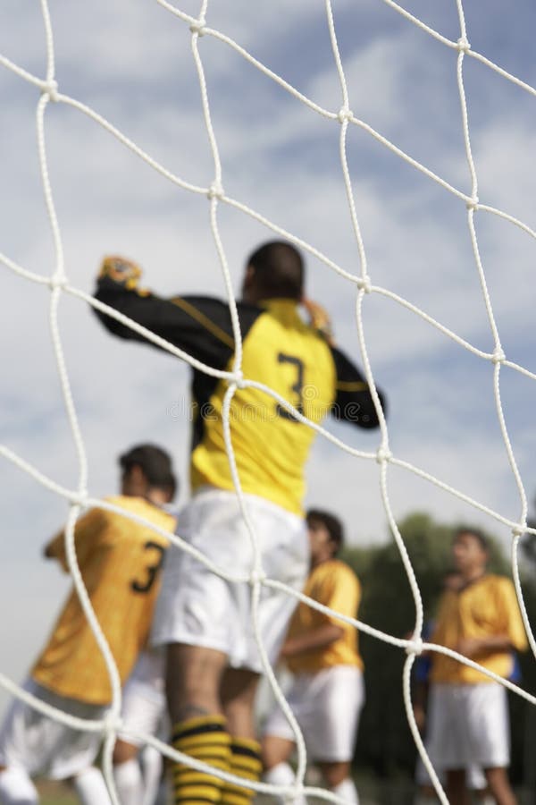 Goalkeeper Jumping for Soccer Ball Stock Photo Image of yellow