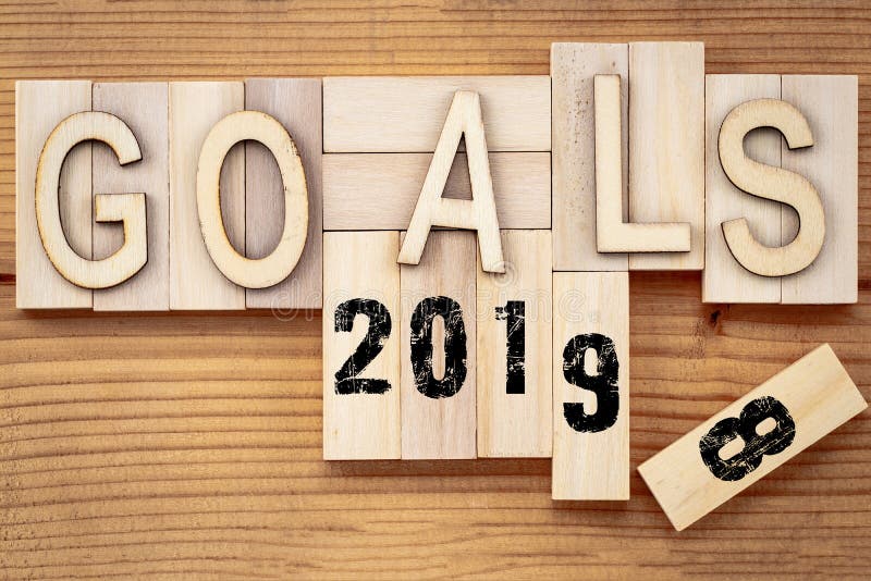 Goals 2018 change to 2019 concept. Wooden block cube with number on table.