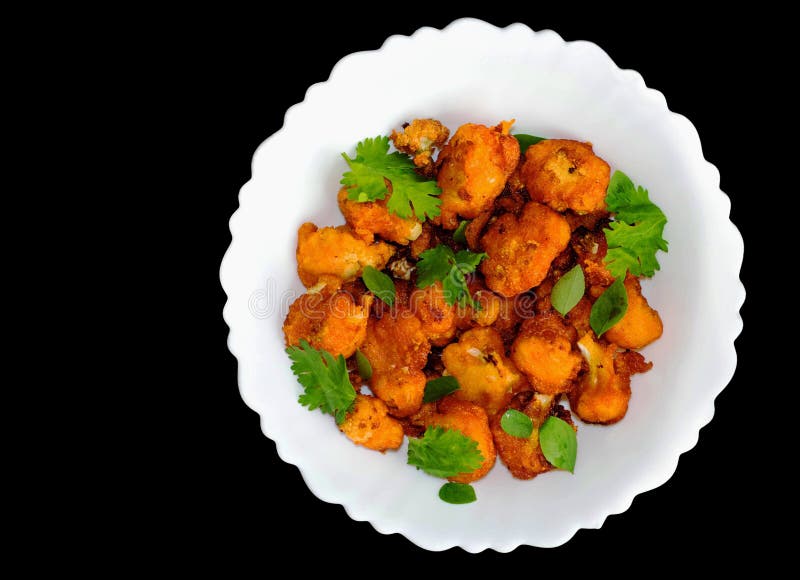 Tasty and crispy gobi manchurian&#x28;Cauliflower&#x29; dry fry served in white plate with decoration. Tasty and crispy gobi manchurian&#x28;Cauliflower&#x29; dry fry served in white plate with decoration