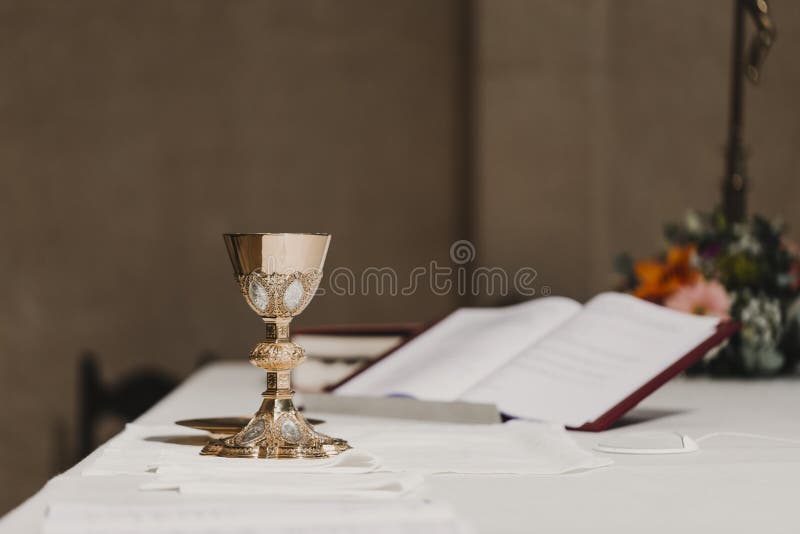 Goblet of wine on table during a wedding ceremony nuptial mass. Religion concept. Goblet of wine on table during a wedding ceremony nuptial mass. Religion concept