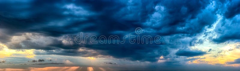 God light rays piercing through heavy clouds, panorama format royalty free stock photos