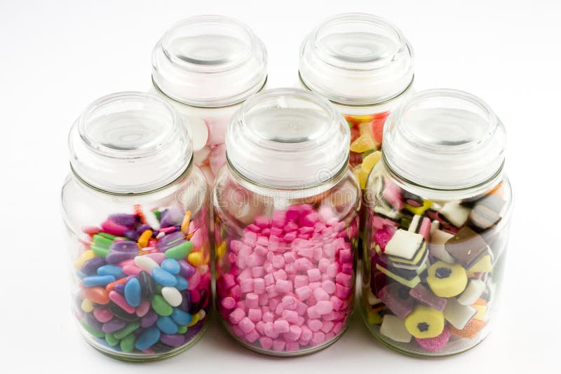 Glass jars filled with assorted sweets and candy. Glass jars filled with assorted sweets and candy