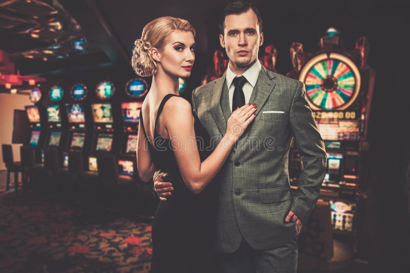 Goed-gekleed retro stijlpaar in casino royalty-vrije stock foto Goed-gekleed retro stijlpaar in casino royalty-vrije stock foto