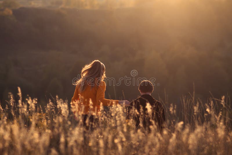 Young happy beautiful couple has romantic date on hills outdoors