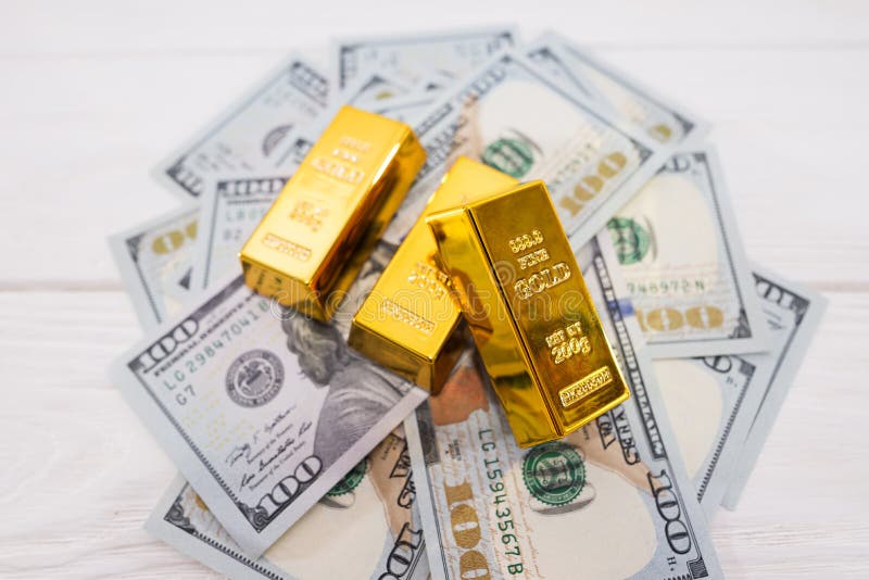 Gold Bars and Calculator on 100 New US Dollar Banknotes Stock Image