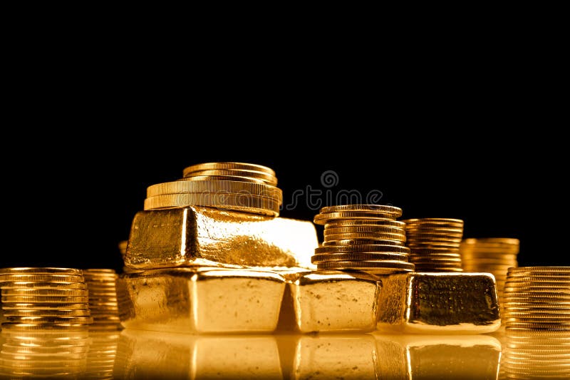 Gold bullions and stack of coins. Background for finance banking concept. Trade in precious metals.