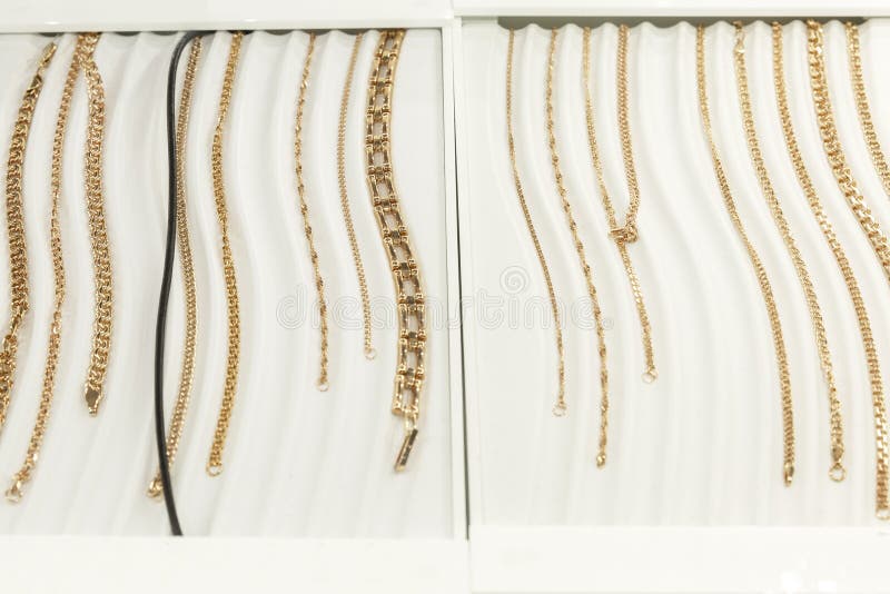 Gold Chains and Bracelets on Display in a Jewelry Store. Front View