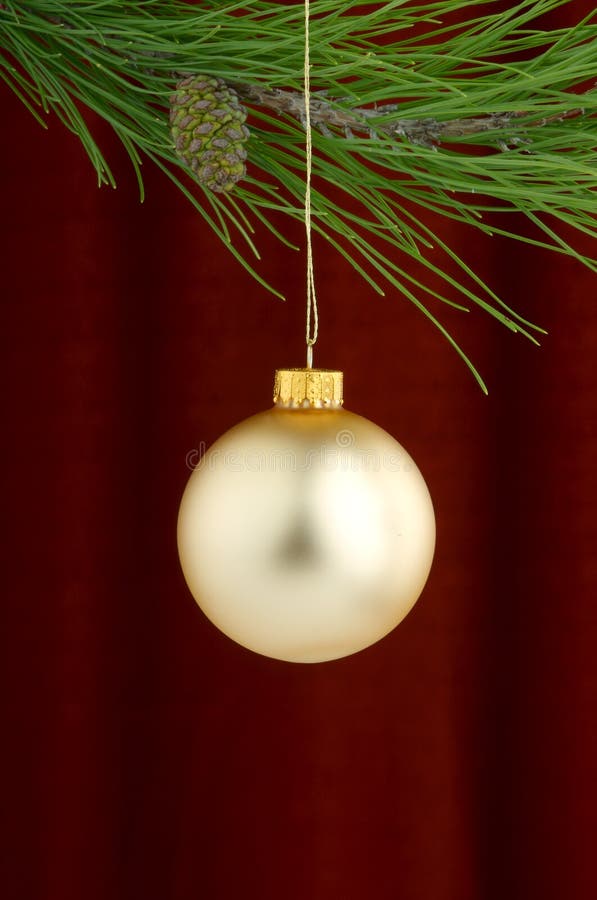 Gold Christmas ornaments on burgundy background