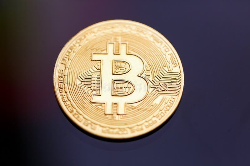 The gold coin bitcoin on a black background stock photos The gold coin bitcoin on a black background stock photos