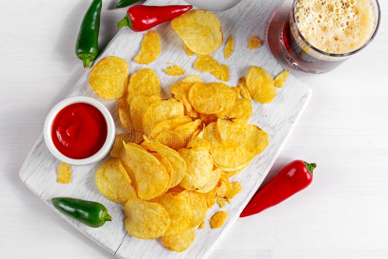 Gold and Crispy Potato Chips with Hot Sauce, Beer on White Board