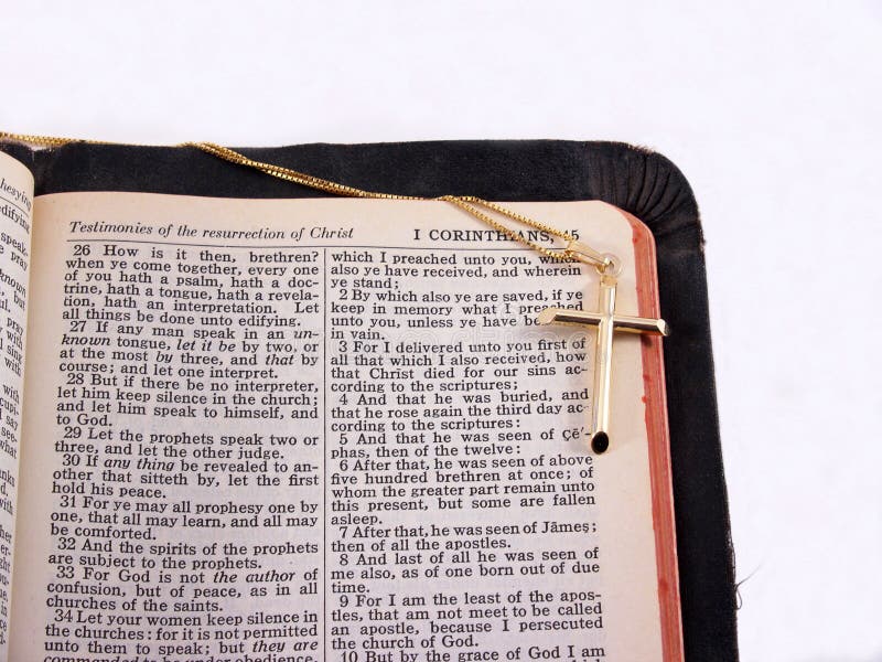 Gold cross on Bible open to I Corinthians 15. Gold cross on Bible open to I Corinthians 15