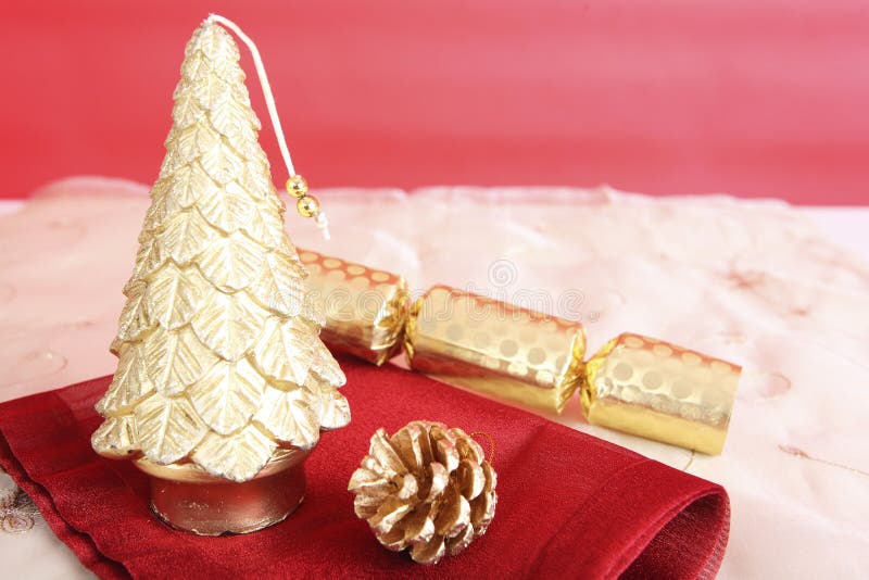 Gold Decorative Christmas Tree, Pine Cone and Christmas Cracker. Conceptual Image Stock Image