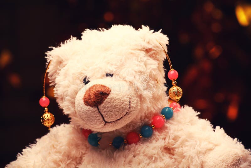 Gold earrings pink blue agate stone beads toy bear gold bokeh stock images Gold earrings pink blue agate stone beads toy bear gold bokeh stock images