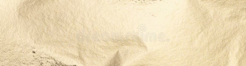 Gold foil texture with a soft, pale background. Smooth, shiny surface with subtle shimmer and stock photography