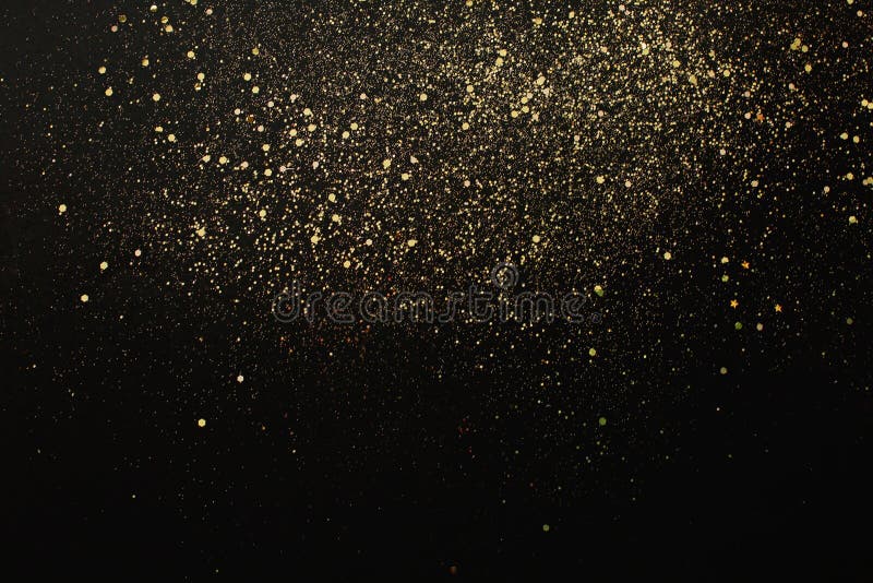 Gold Glitter on Black Background. Holiday Abstract Texture Stock Image