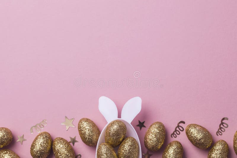 Gold Glitter Eggs in a White Easter Bunny Egg Shape with Ears Stock