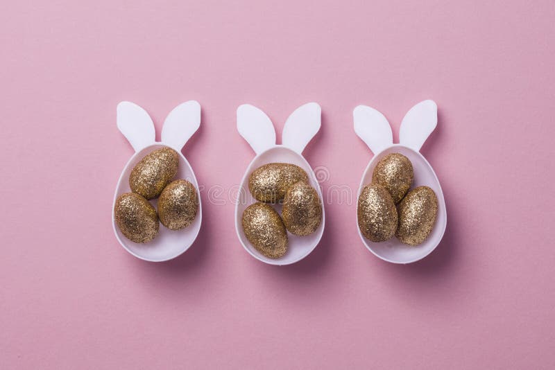 Gold Glitter Eggs in a White Easter Bunny Egg Shape with Ears Stock
