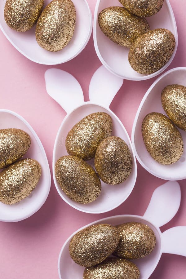 Gold Glitter Eggs in a White Easter Bunny Egg Shape with Ears Stock