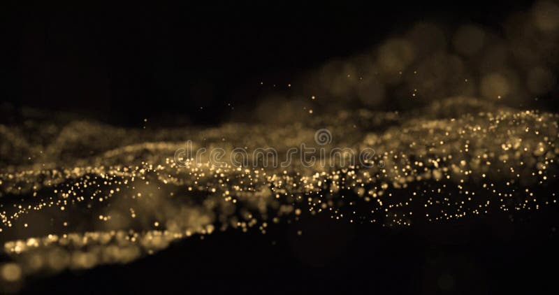 Gold glitter light particles splash wave, bokeh effect on black background. Shining gold sparks, shimmering sparkles glow in wave