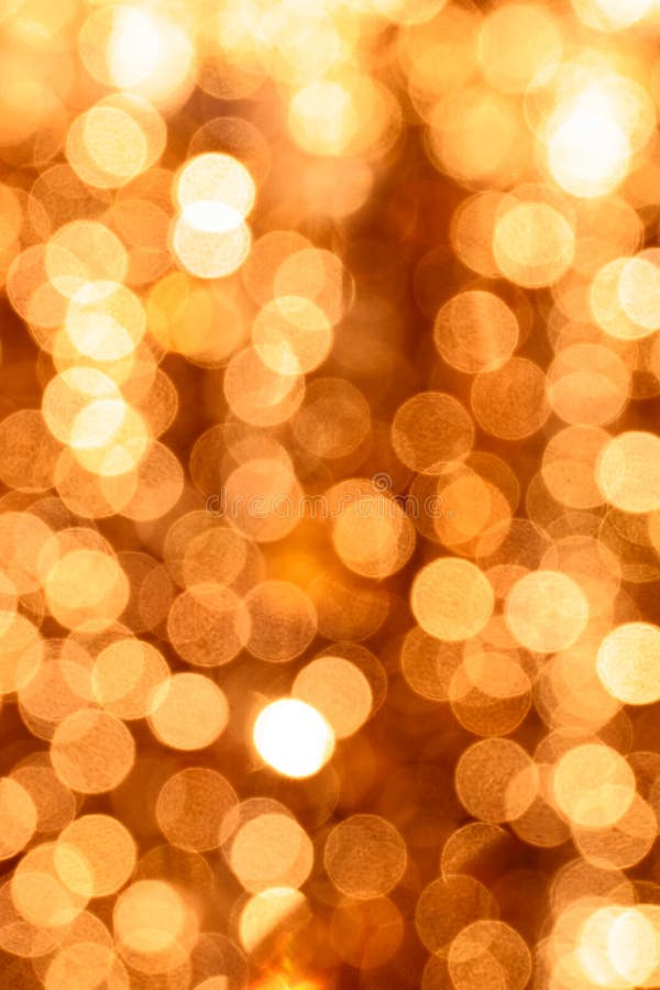 Gold Glittering Christmas Lights Bokeh. Blurred Abstract Background