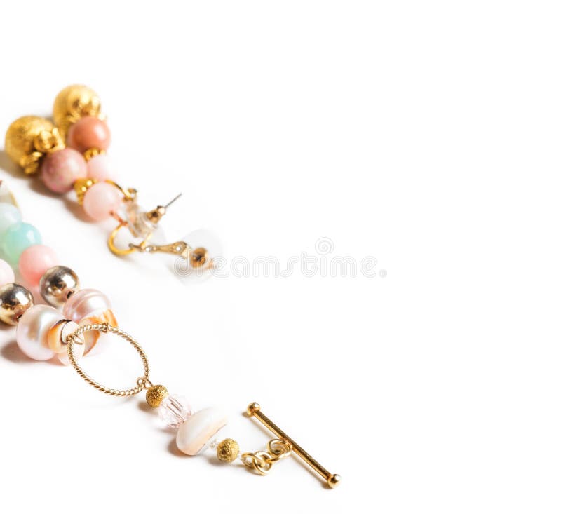 Gold jewerly braslete and earrings with semiprecious at white ba royalty free stock photography Gold jewerly braslete and earrings with semiprecious at white ba royalty free stock photography