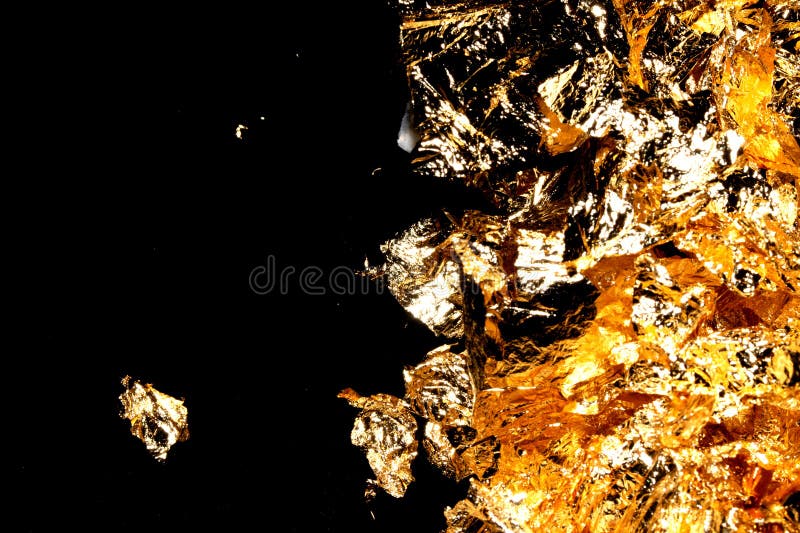 Gold Leaf Pieces Close Up on a Black Background As Decorative Pieces