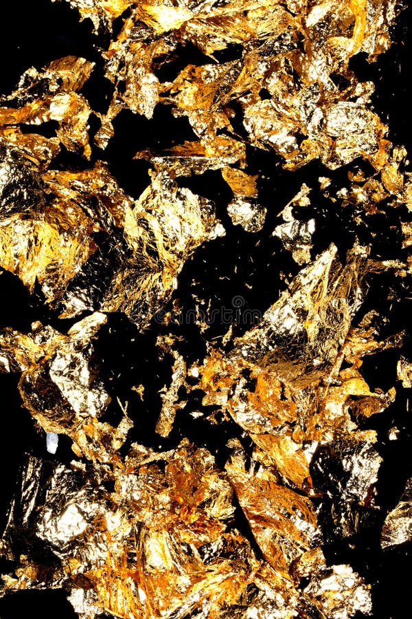 Gold Leaf Pieces Close Up on a Black Background As Decorative Pieces