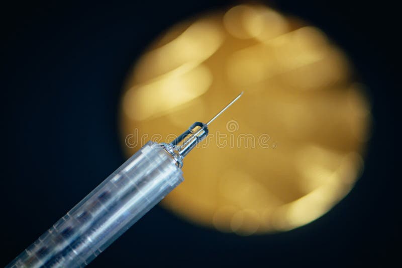 Gold medal and syringe. Doping and drugs in sport, concept photo. Black background. High Quality Photo. Natural Light