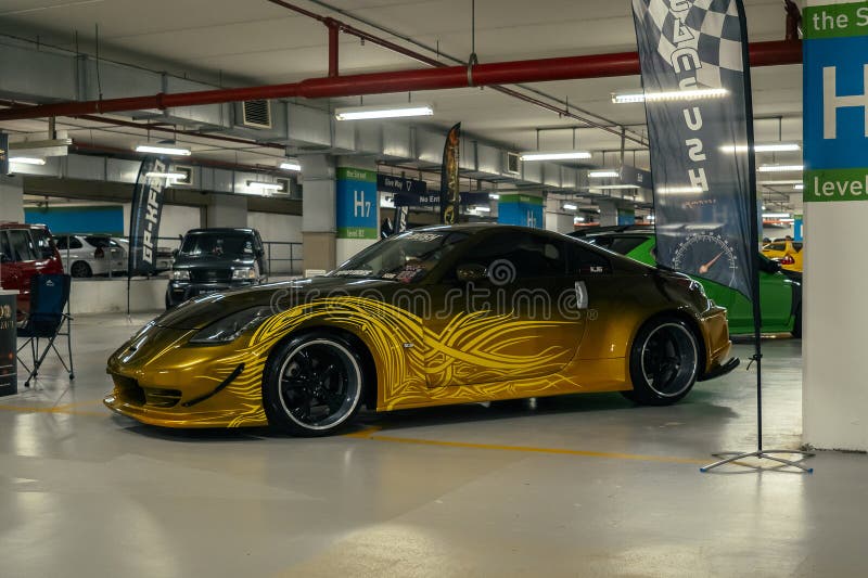 Gold Nissan 350Z on display.