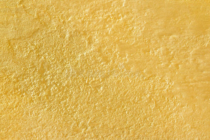 The Gold Paint on Rough Cement Wall Texture. Gold Background Stock