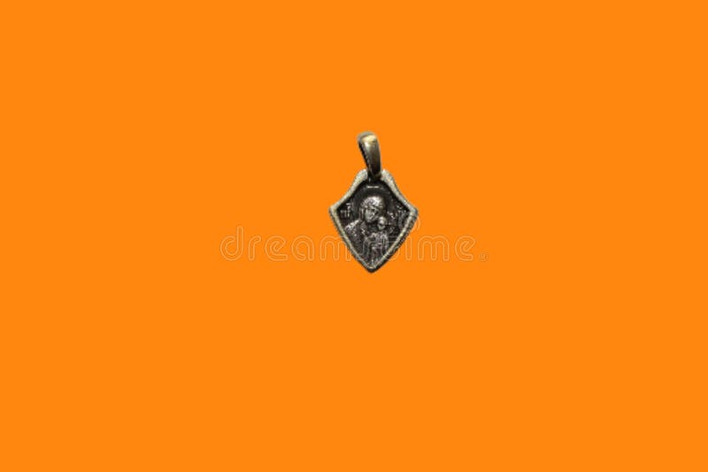 Gold pendant with image of Virgin Mother royalty free stock photography