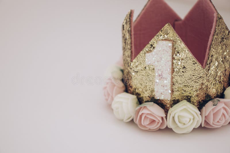 Gold and pink first birthday crown on pink background stock photos Gold and pink first birthday crown on pink background stock photos