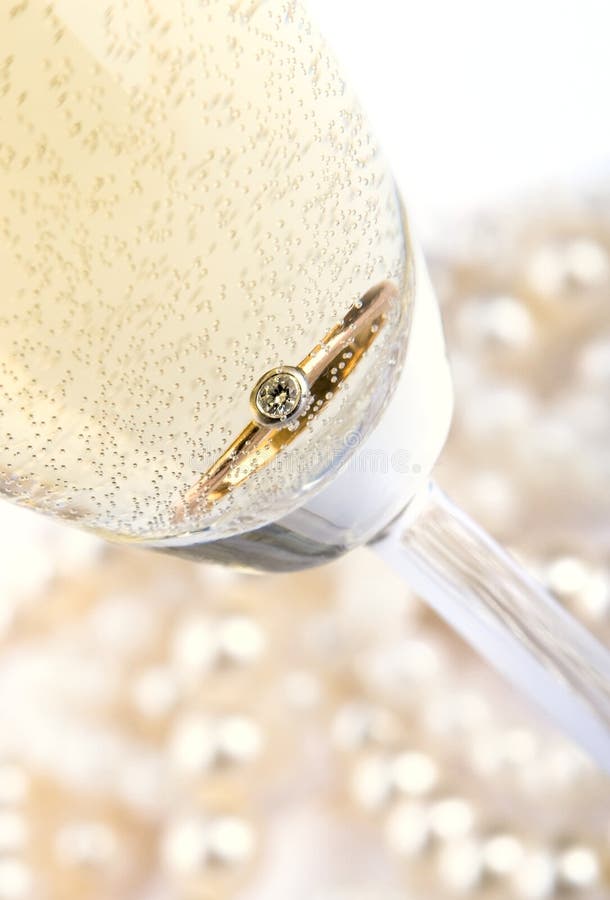Gold ring in champagne stock photo. Image of diamonds 5316560