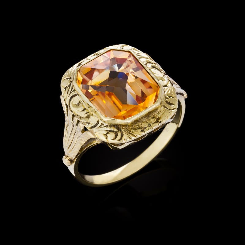 Gold ring with gemstone on black background