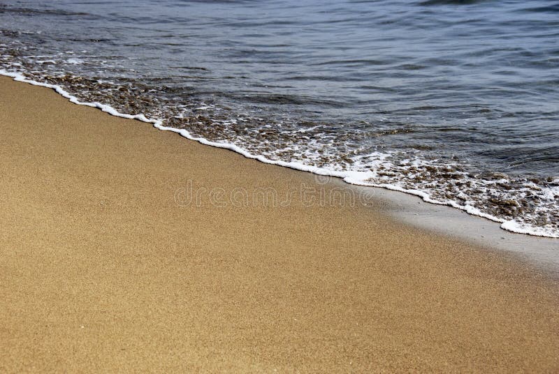 Gold sand and sea foam stock photo