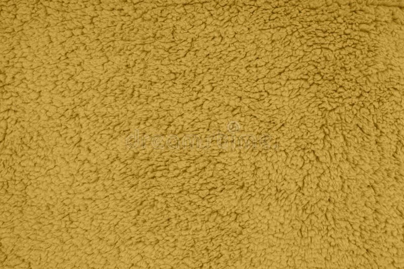 Gold sherpa textured plush fabric material background stock image