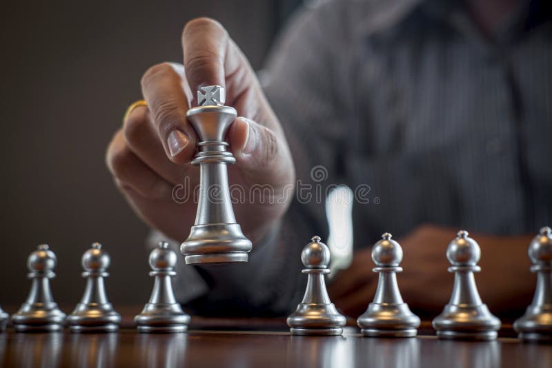 Gold and silver chess with player, Intelligent businessman playing chess game competition to planning business strategic to development for win and success