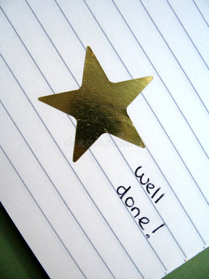 Gold star sticker in an exercise book with words well done. Gold star sticker in an exercise book with words well done