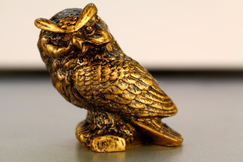 Gold Statuette of an Owl from the Background, Wallpaper Stock Photo