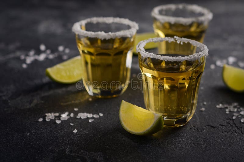 Gold Tequila with Lime and Salt Rim on Dark Stone or Concrete ...