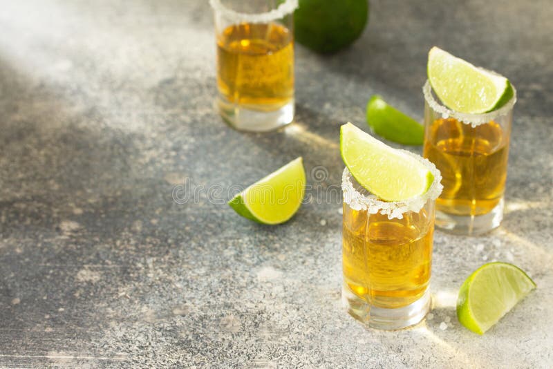 Gold Tequila. Mexican Gold Tequila Shot with Lime and Salt Stock Image