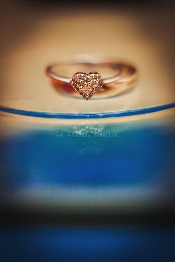 Gold Wedding Rings Heartshaped Stock Image Image of lines, blue
