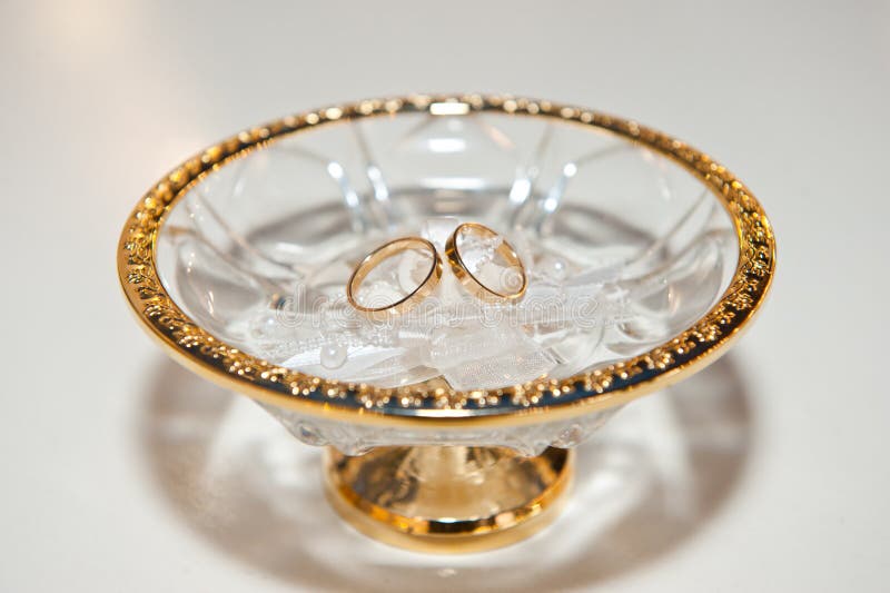 Gold Wedding Rings Lying in a Beautiful Plate with a Gold Border Stock