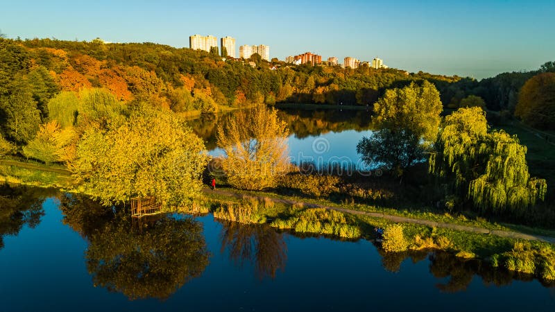 Golden autumn background, aerial drone view of forest with yellow trees and beautiful lake landscape from above, Kiev royalty free stock photo Golden autumn background, aerial drone view of forest with yellow trees and beautiful lake landscape from above, Kiev royalty free stock photo