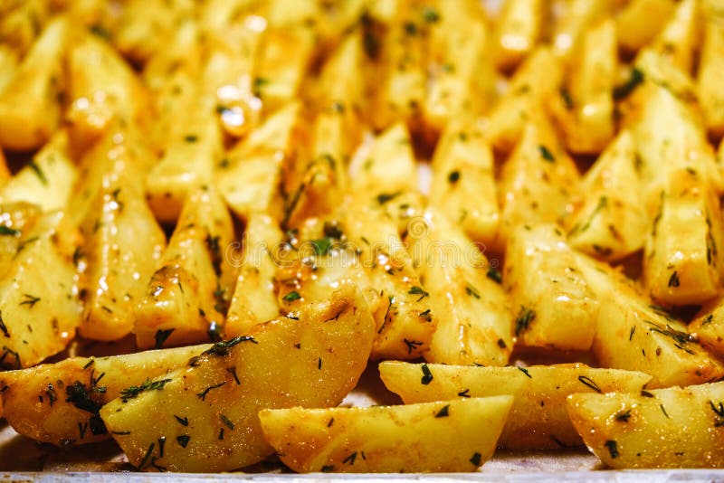 The Golden Baked Potatoes with Herbs from the Oven Stock Photo Image