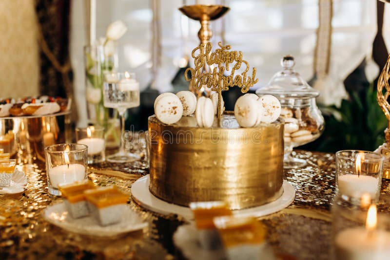A golden birthday cake is decorated with macaroni royalty free stock images A golden birthday cake is decorated with macaroni royalty free stock images