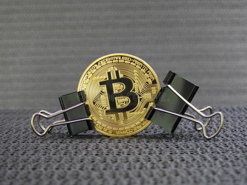 Golden Bitcoin clamped royalty free stock photography