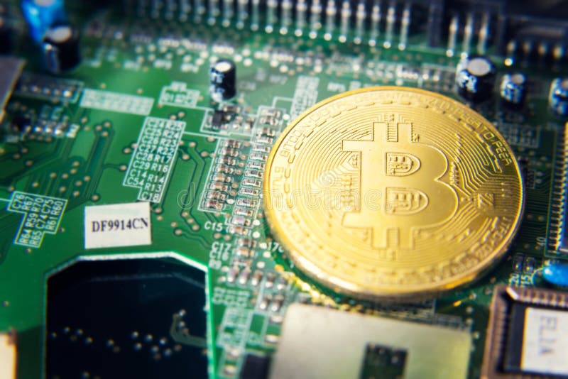 Golden bitcoin coin lying on computer motherboard, cryptocurrency mining concept stock photo Golden bitcoin coin lying on computer motherboard, cryptocurrency mining concept stock photo