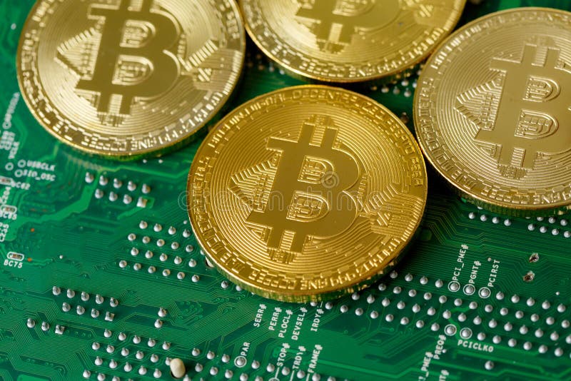 Golden Bitcoin Cryptocurrency On Computer Circuit Board CPU stock photos